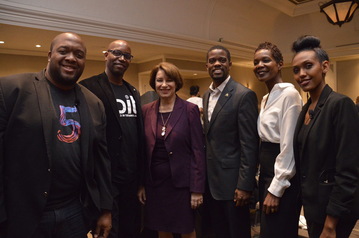 Christopher Lafayette standing with a group of collaborators at a gathering.