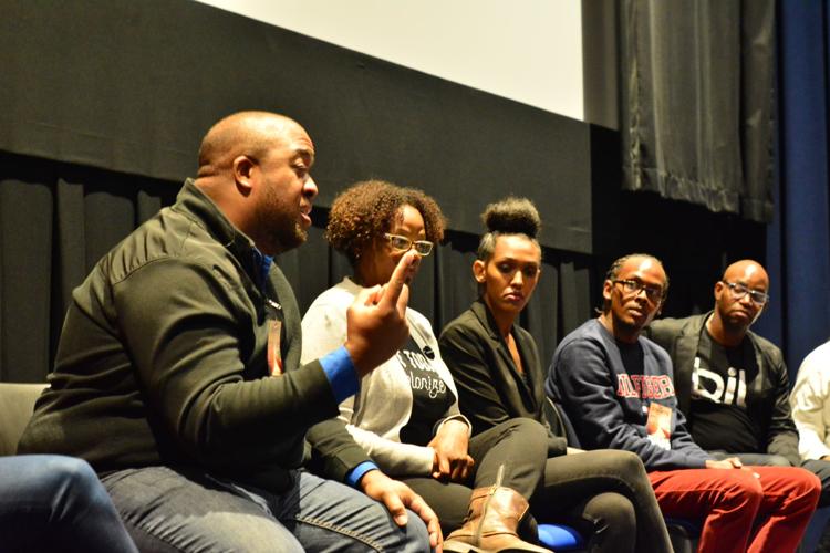 Christopher Lafayette speaking during a seated panel discussion.