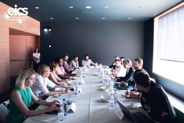 EICS attendees seated around a long meeting table.