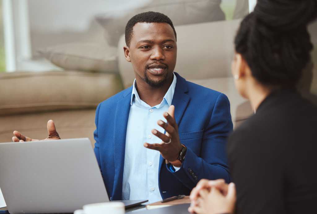CIO’s stock article photograph of a man in a blue jacket speaking in a meeting.